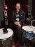 Frank Ferrer seated behind a drum kit in a recording studio.